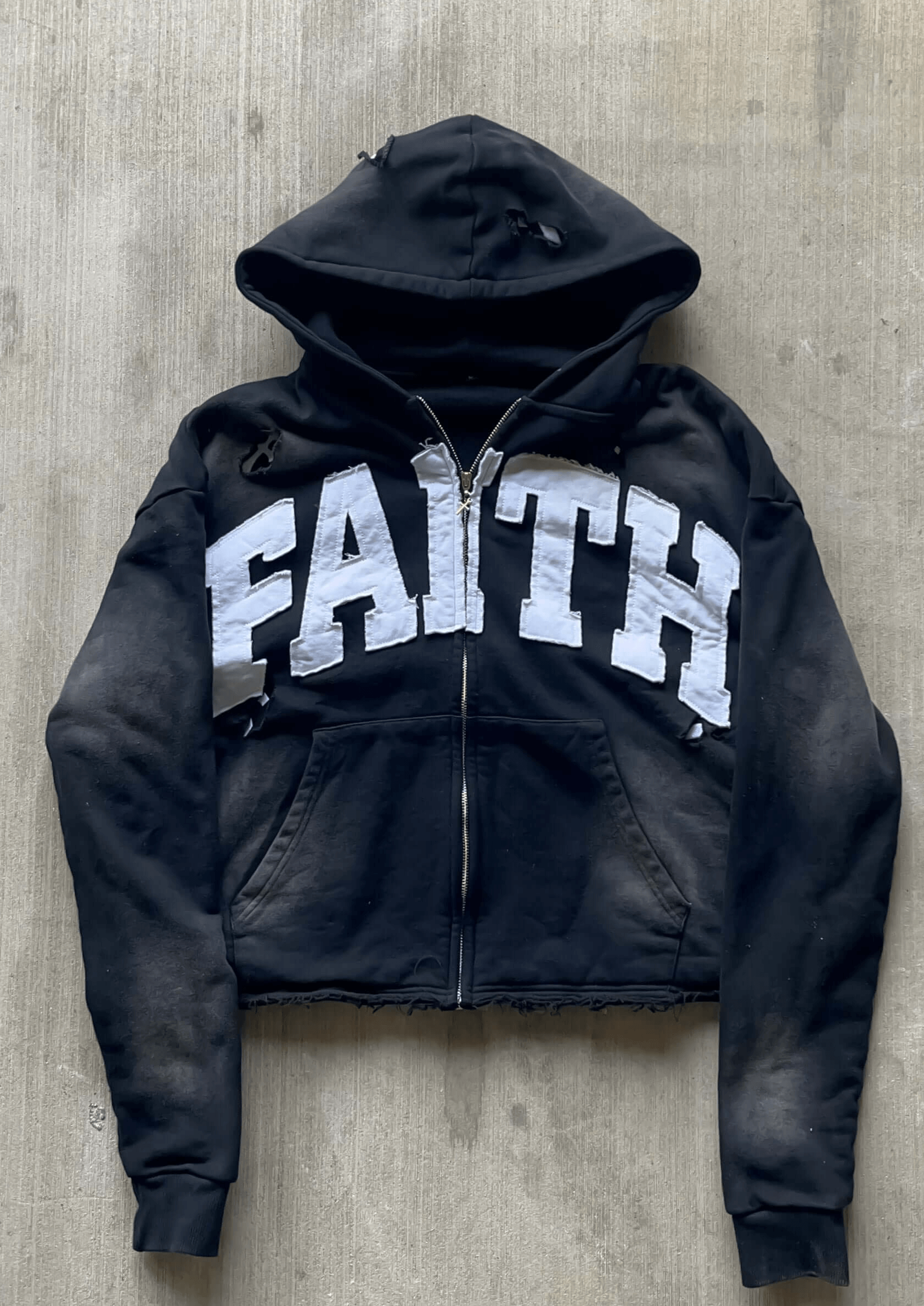 Black Faith distressed zip-up hoodie with edgy cropped fit and unique artistic distressing.